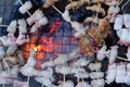 Top view Close up Grilling bacon roll skewers on grilling basket charcoal Royalty Free Stock Photo