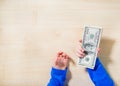 Close-up of hands counting money. Happy child with money dollar, little businessman. Pile of United States dollar hundred USD Royalty Free Stock Photo