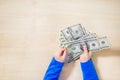 Close-up of hands counting money. Happy child with money dollar, little businessman. Pile of United States dollar hundred USD Royalty Free Stock Photo