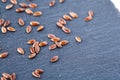 Top view close-up picture of separate flax seed on dark grey background, macro.