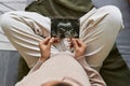 Top view close up of pregnant woman holding ultrasound picture of baby Royalty Free Stock Photo