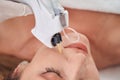 Joyful woman doing beauty injections for face Royalty Free Stock Photo