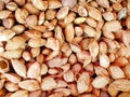 Top view, close up raw cracked unpeeled almonds, nut background, situated arbitrarily, Natural texture, background