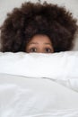 Top view close up scared black kid hiding under duvet. Royalty Free Stock Photo