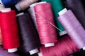 Top view close up of scattered colorful cotton thread coils with needle Royalty Free Stock Photo