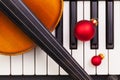 Top view close up shot of piano keyboard,old violin and Christmas decoration. Royalty Free Stock Photo