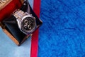 Top view close up of a silver wrist watch with wood case and blue background. Men gifts concept Royalty Free Stock Photo