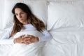Top view thoughtful woman lying in empty bed alone Royalty Free Stock Photo