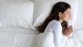 Top view unhappy woman lying in bed, feeling lonely