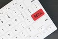 Top view and close up of white computer keyboard with red sell button on desktop. Online advertisement concept. Royalty Free Stock Photo