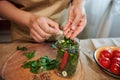 Top view. Close-up of a woman putting peppercorns into a canning jar while pickling chili peppers. Harvest conservation Royalty Free Stock Photo