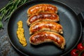 Top view closeip fried sausages on round pan with granular mustard