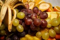 top view closeup assorted grapes and sliced tropical fruits Royalty Free Stock Photo