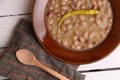 Top view closeup of a bowl of bean soup topped a yellow cayenne