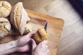 Caucasian male cutting bread on woodboard Royalty Free Stock Photo