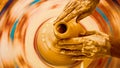 Top view closeup of a craftsman's hands working on the pottery wheel Royalty Free Stock Photo