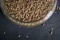 Top View Closeup Cumin seeds in a Open Transparent Glass jar On isolated Black Background Royalty Free Stock Photo