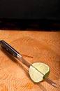 Lime being sliced with a serrated blade, knife