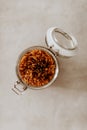 Top view closeup of a glass jar container full with uncooked spaghetti pasta on grey background Royalty Free Stock Photo