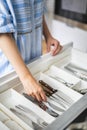 Top view closeup housewife hands tidying up cutlery in drawer general cleaning at kitchen