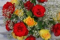 Top view closeup of isolated fresh cut flowers bouquet with red and yellow roses, white gypsophila paniculata for decoration Royalty Free Stock Photo