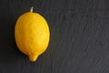 Top view in closeup of a lemon on black background