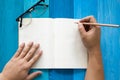 Top view of closeup male hand written notebook on the table