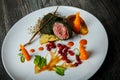 Top view closeup medium raw meat decorated with carrot and viburnum berries