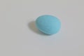 Top view closeup of one piece of a blue candy isolated on a grey background Royalty Free Stock Photo