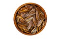 Top view closeup pile of salty roasted sunflower seeds with shell in wooden bowl isolated on white background Royalty Free Stock Photo