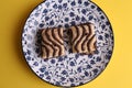 Top view closeup of a plate of two chocolate drizzled biscuits Royalty Free Stock Photo