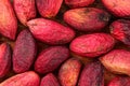 Top view closeup of raw turkish red pistachios, skin wrinkled after couple of days. Nuts and green seeds are under