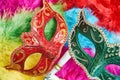 Top view, Closeup red and green venetian masquerade, Carnival mask, opera mask on colorful fluffy Royalty Free Stock Photo