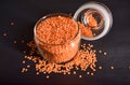 Top View Closeup Red Lentils in a Open Transparent Glass jar On isolated Black Background Royalty Free Stock Photo