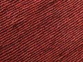 Top view closeup of red polyester material used for a line of stitches background