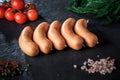 top view closeup row of thick sausages with dill and tomatoes Royalty Free Stock Photo