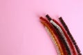 Top view closeup shot of colorful pipe cleaners for craft making on a pink background Royalty Free Stock Photo