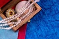 Top view closeup shot of a quartz necklace with amber stone ring and sea shell in a wooden box. Classic gifts concept Royalty Free Stock Photo