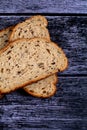 Top view closeup of a sliced loaf of brown bread on a wooden table Royalty Free Stock Photo