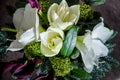 Top view closeup on white and cream lily, purple calla flowers and fresh greenery Royalty Free Stock Photo