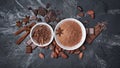 Top view of cocoa powder and chocolate chips in white bowls and whole cocoa beans with spices