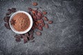 Top view of cocoa powder in white bowl with chunks of chocolate and whole cocoa beans Royalty Free Stock Photo