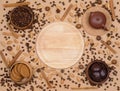 Top view coffee beans, teapot, oatmeal cookies and chocolate biscuit with spice on beige background