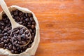 Top view of coffee beans on wooden spoon on wooden background Royalty Free Stock Photo