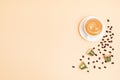 Top view of coffee capsules and cup over beige background with copy space. Morning dose of caffeine, energy, flavor