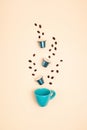 Top view of coffee capsules and cup over beige background with copy space. Morning dose of caffeine, energy, flavor