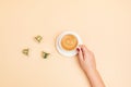 Top view of coffee capsules and cup over beige background with copy space. Morning dose of caffeine, energy, flavor