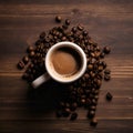 Top view of Coffee Cup and Beans on Wooden Table. Cup of hot aromatic coffee and coffee beans on wooden table. Warm cup of coffee Royalty Free Stock Photo