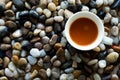 Top view of coffee cup on black stones. Royalty Free Stock Photo