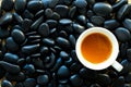 Top view of coffee cup on black stones. Royalty Free Stock Photo